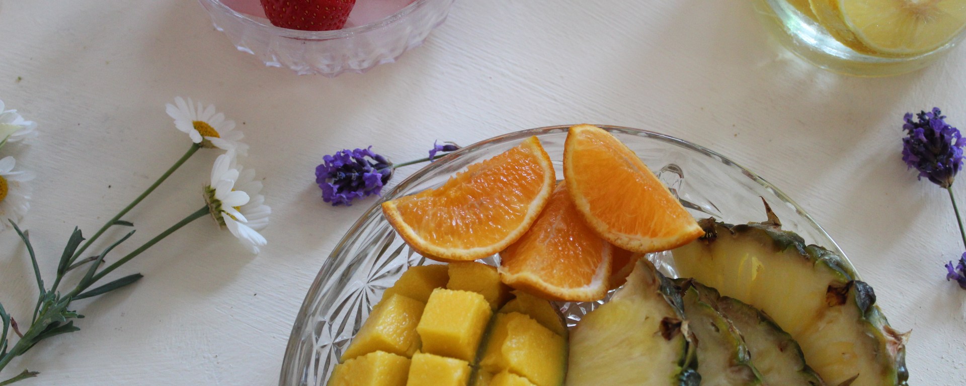Fruit platter with mango, orange, pineappe, strawberries and lemon.