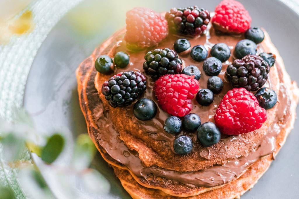 Pancakes with raspberries, blackberries, blueberries and chocolate spread.